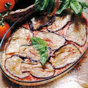 Parmigiana di melanzane with layered aubergine slices and a basil leaf